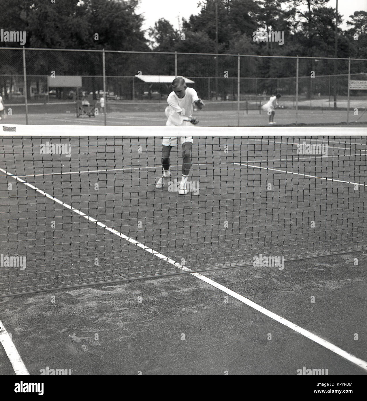 1960s, historical, picture shows a young adult tennis player at the net concentrating on volleying a ball, USA. Stock Photo