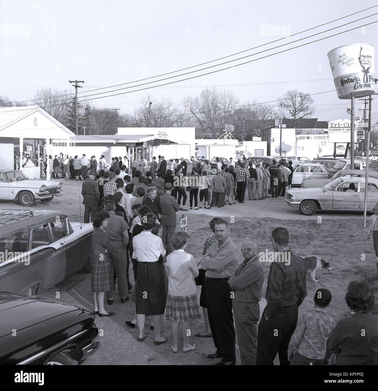 1960s, now that's a long queue...historical picture from this era showing American men and women queuing up outside a Kentucky Fried Chicken fast food outlet in the hope of winning one of the cash prizes on offer inside the store, USA. Stock Photo