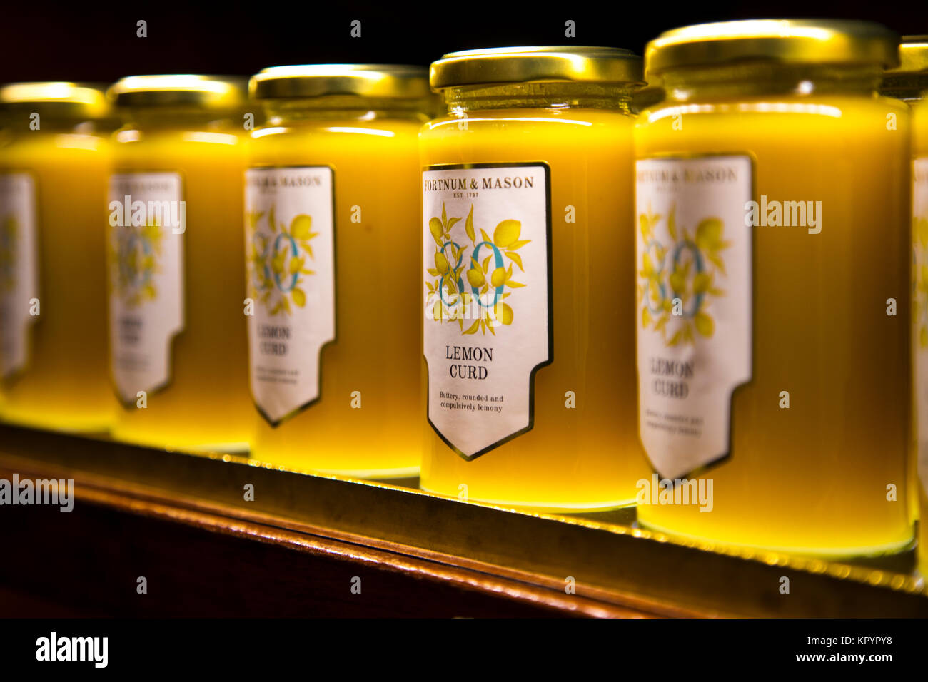 Jars of lemon curs lined up on a shelf at Fortnum & Mason, London, UK Stock Photo