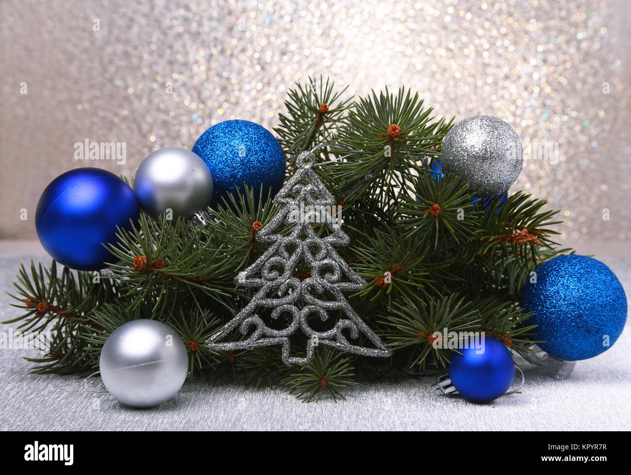 Decorative background with fir branches and red balls on the silver ...
