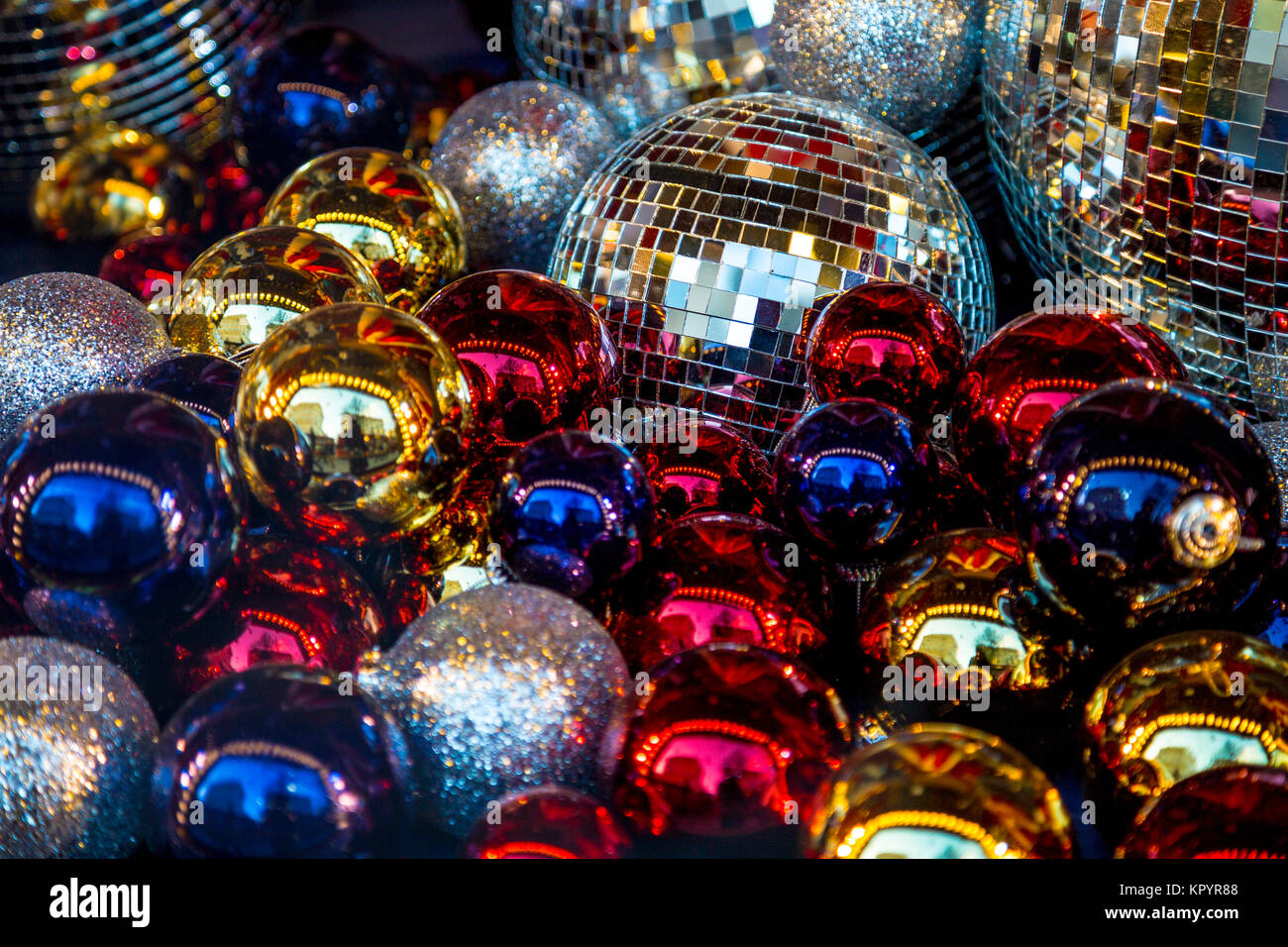 Festive background of shiny colourful Christmas baubles and disco balls Stock Photo