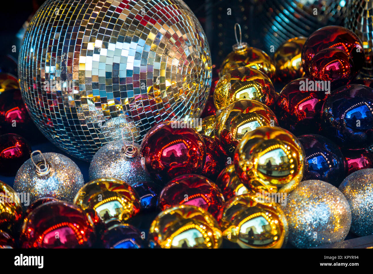 Festive background of shiny colourful Christmas baubles and disco balls Stock Photo