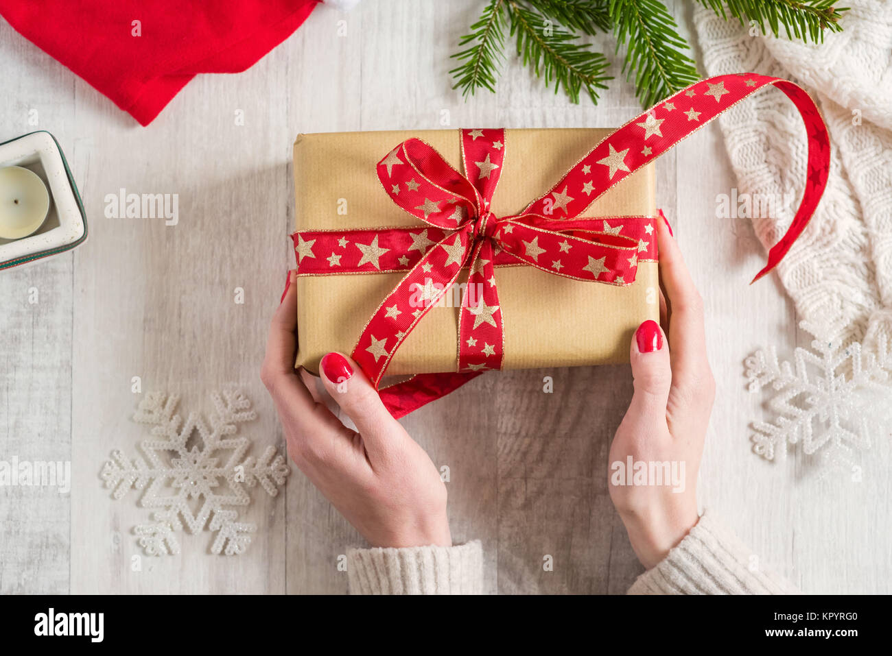 Woman holding a Christmas gift in hands Stock Photo - Alamy