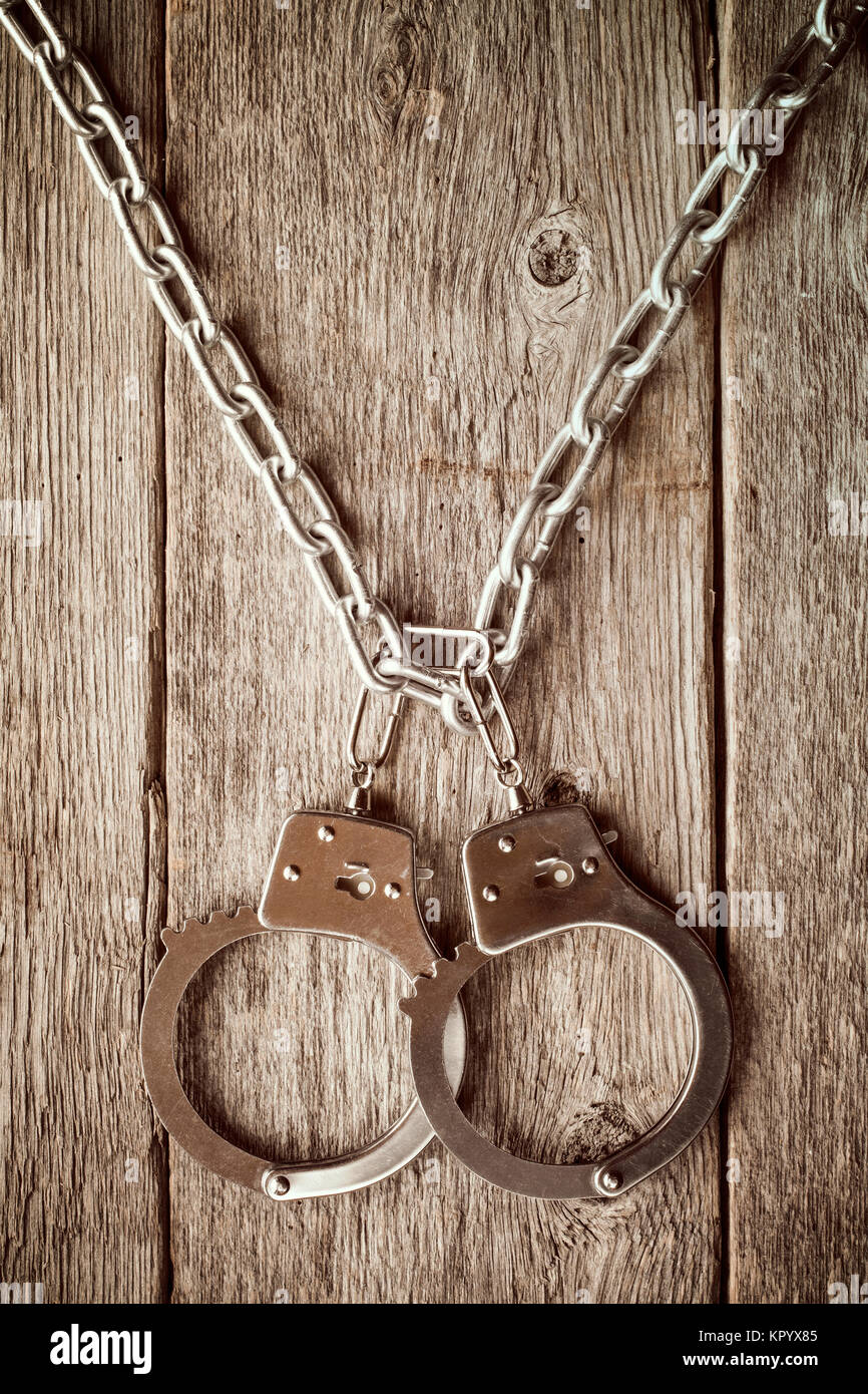 Handcuffs hanging on the chain Stock Photo