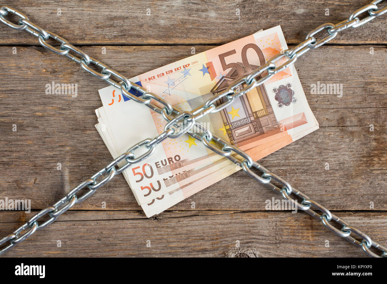 Bunch of fifty euros with chain Stock Photo