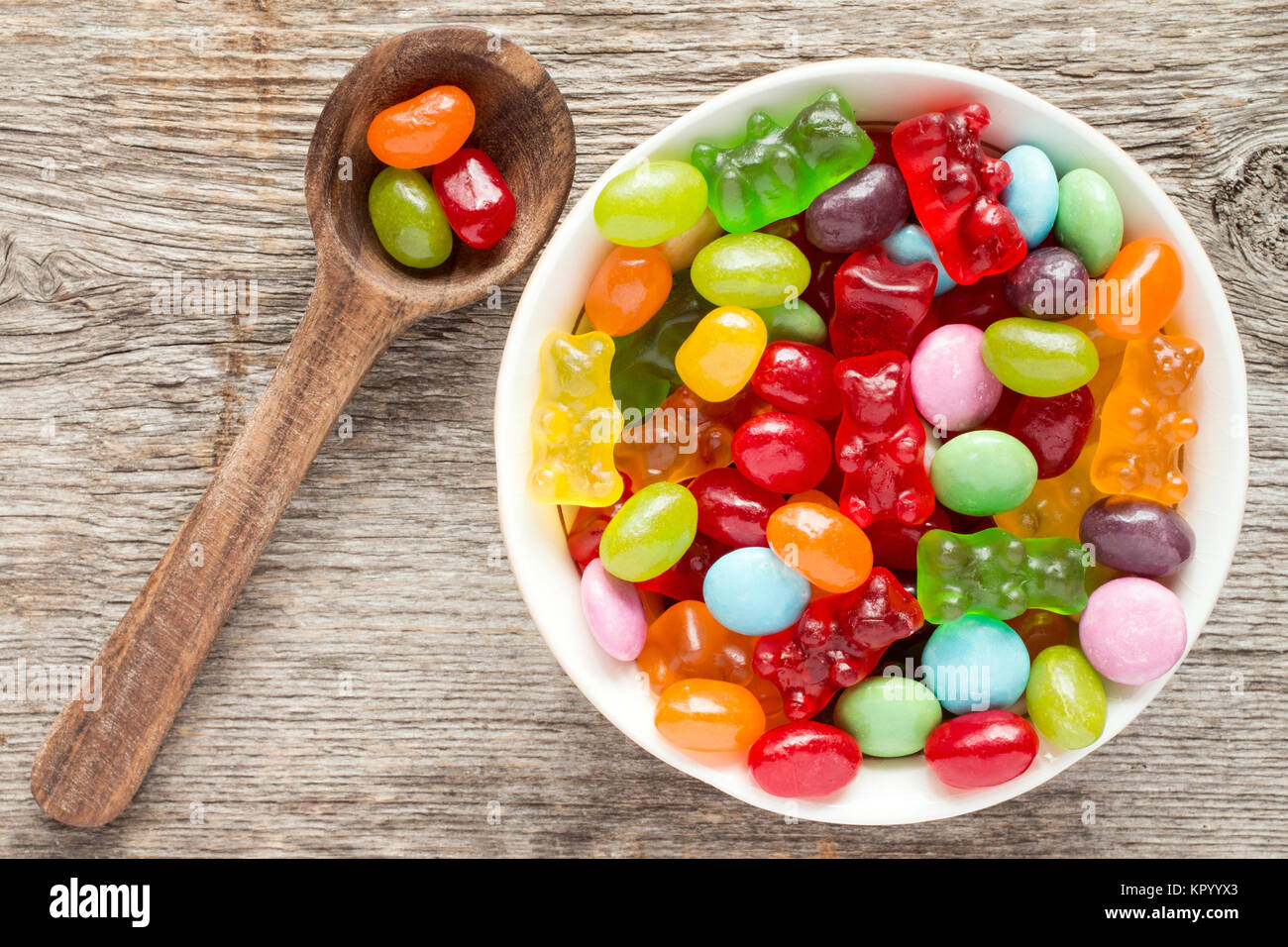 Spoon and bowl  of various candies Stock Photo