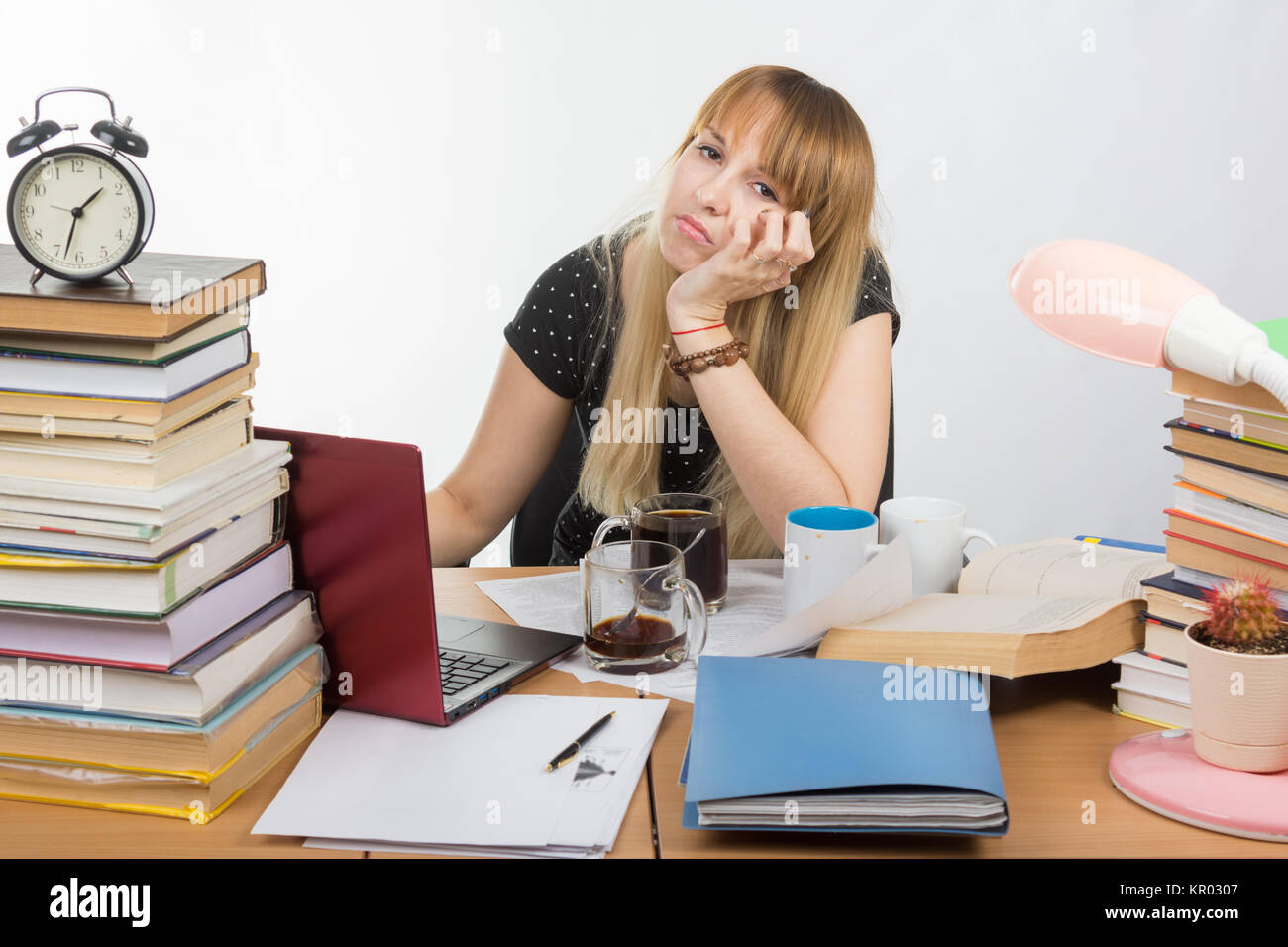 Student doing at night drinking a lot of coffee cups all wanted to