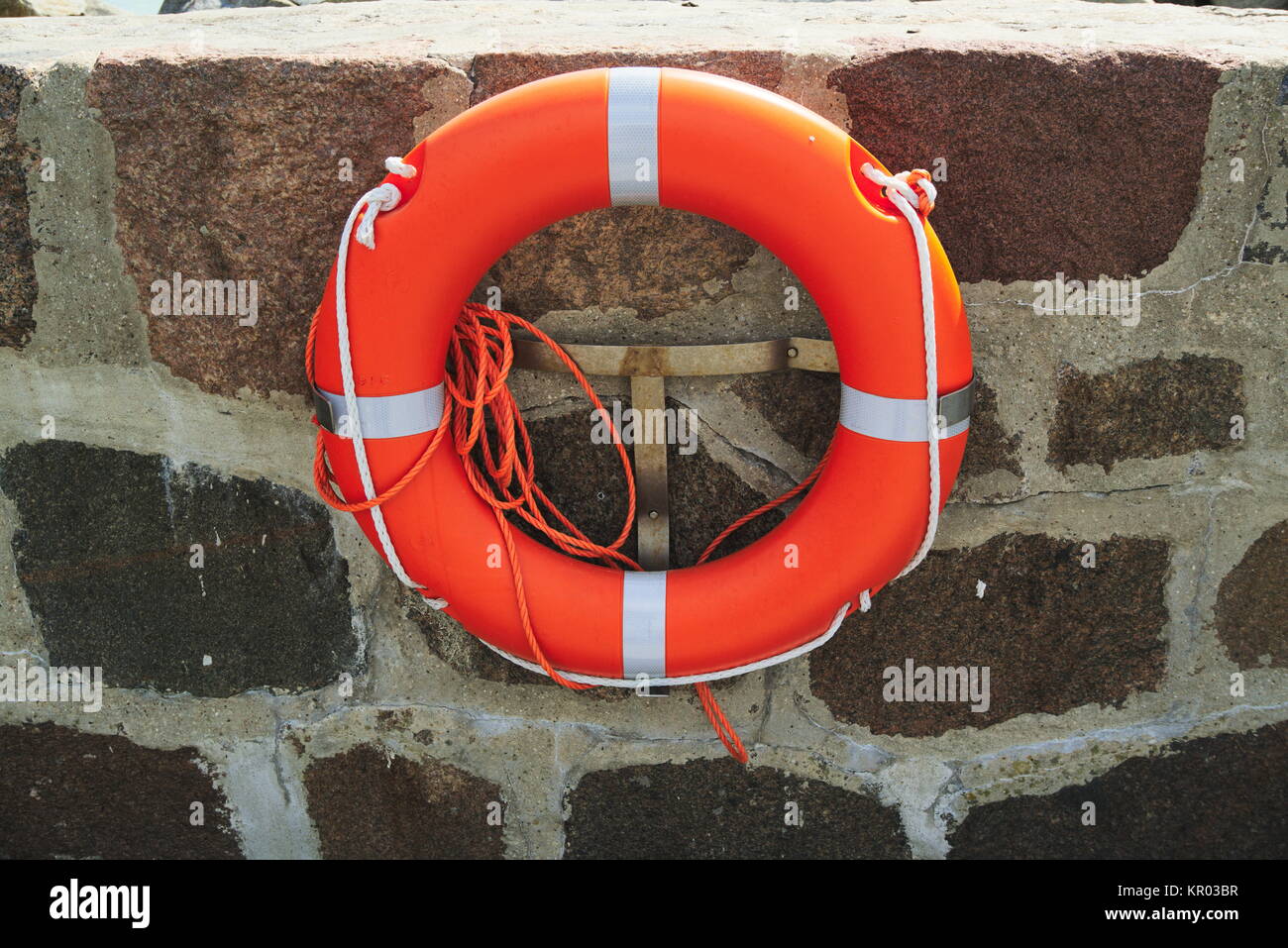 lifebuoy with rope on a wall Stock Photo