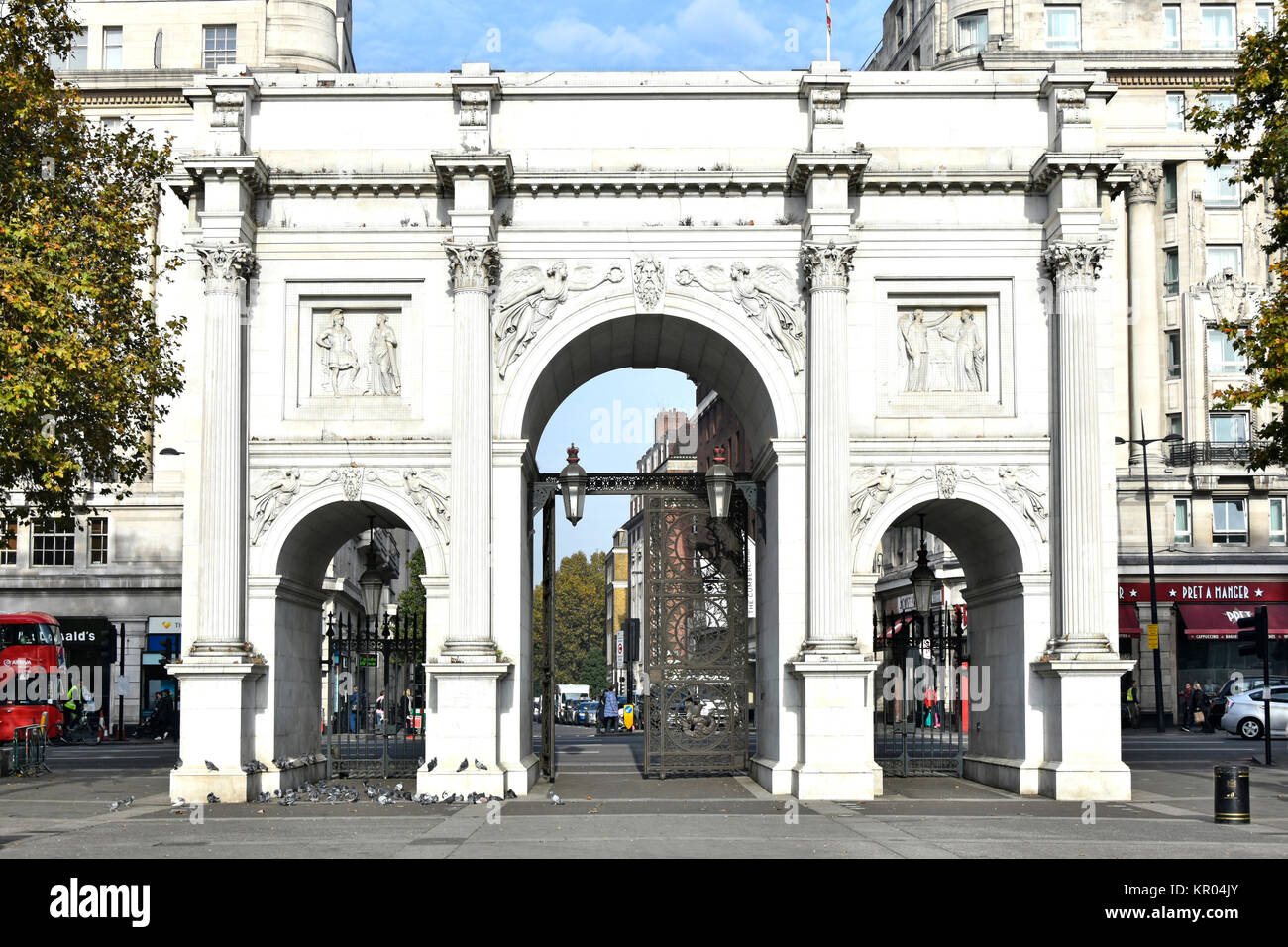 Marble Arch triumphal arch faced in white Carrara marble near Hyde Park relocated to this site in the middle of major traffic junction in 1964 Stock Photo