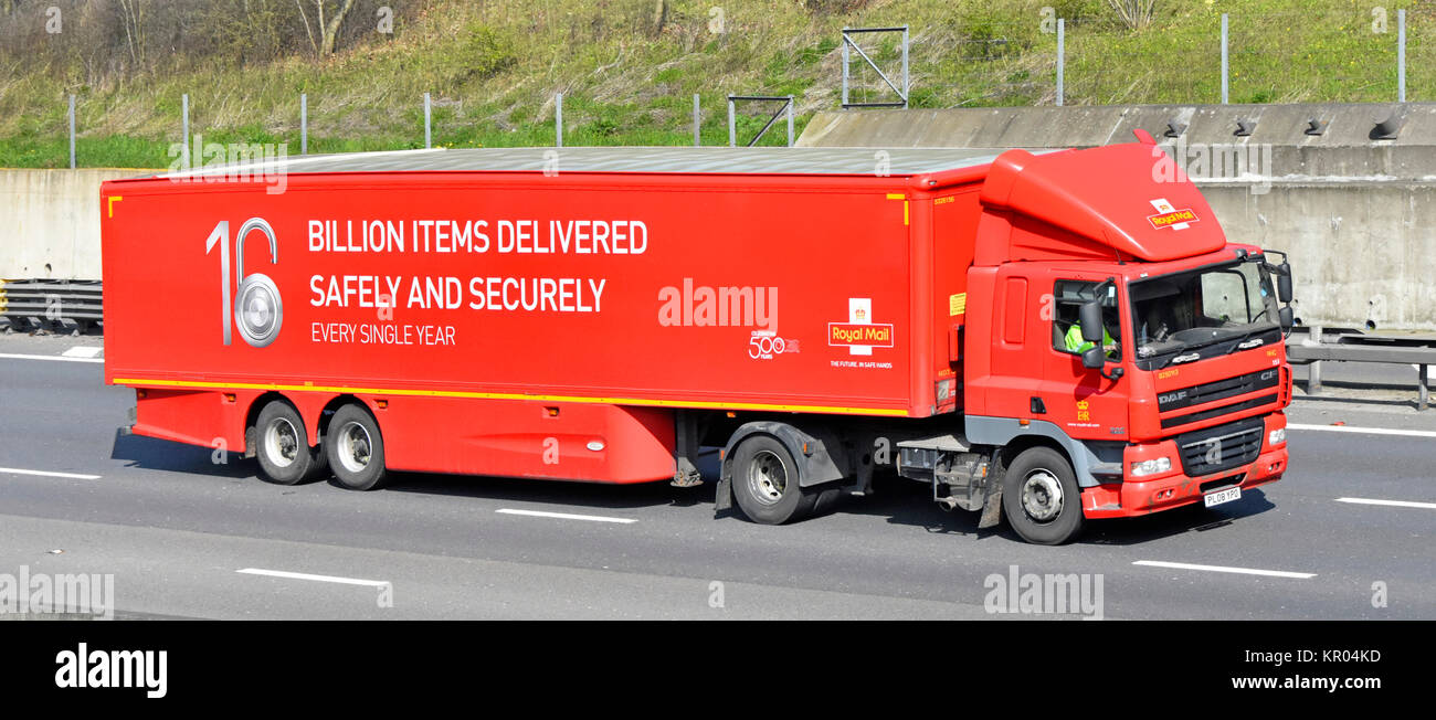 Royal Mail side & front view hgv lorry truck with driver & articulated rigid trailer advertising delivery achievements driving along M25 UK motorway Stock Photo
