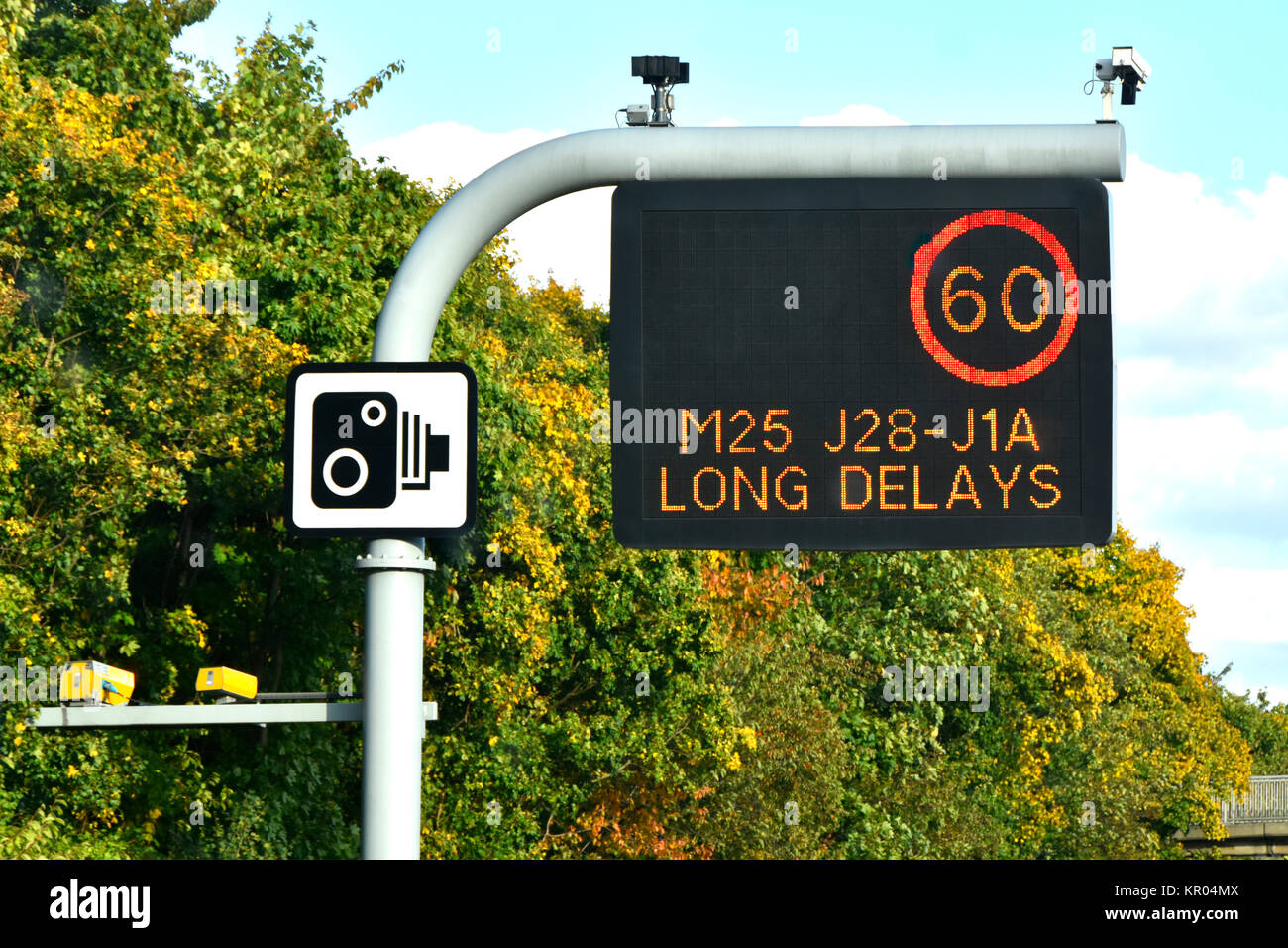 Single panel M25 motorway sign above lane one only, variable speed limit & short delay message complete with CCTV cameras & standard camera sign UK Stock Photo