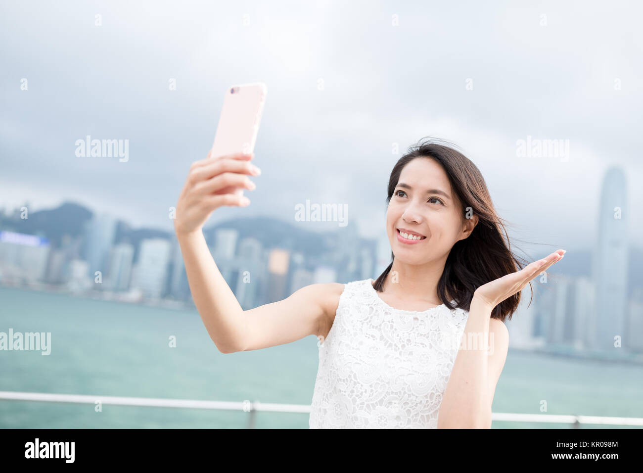 Woman taking selfie in Hong Kong city Stock Photo - Alamy