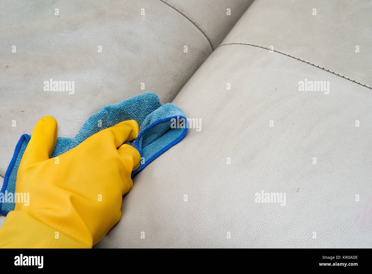 cleaning leather sofa at home with wet towel Stock Photo Alamy