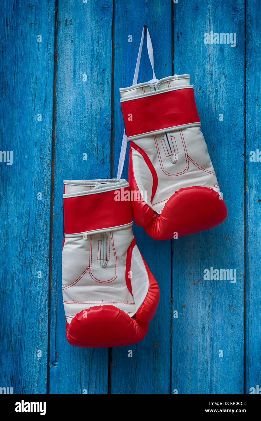 pair of red boxing gloves hanging on a nail Stock Photo Alamy