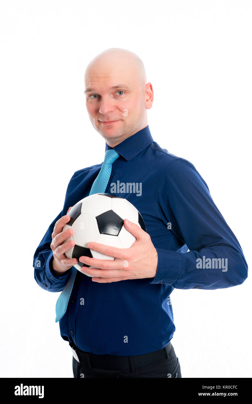 portrait of a young businessman with soccer ball in front of white ...