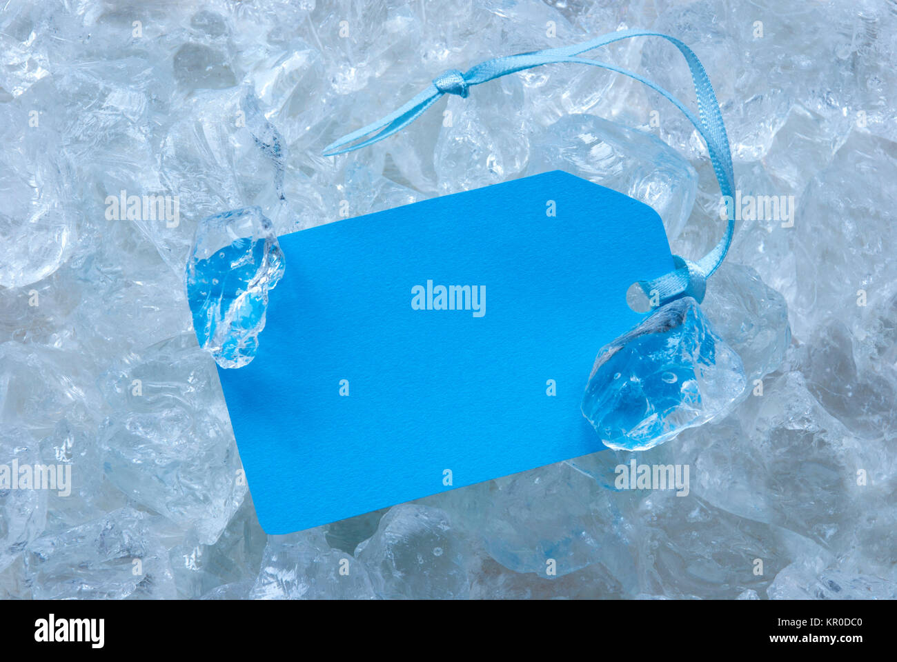 Light Blue Label With Ribbon On White Transparent Curshed Ice Cubes As ...