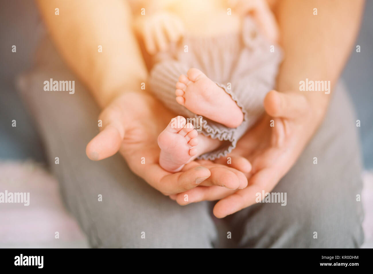 father holding newborn baby little feet Stock Photo