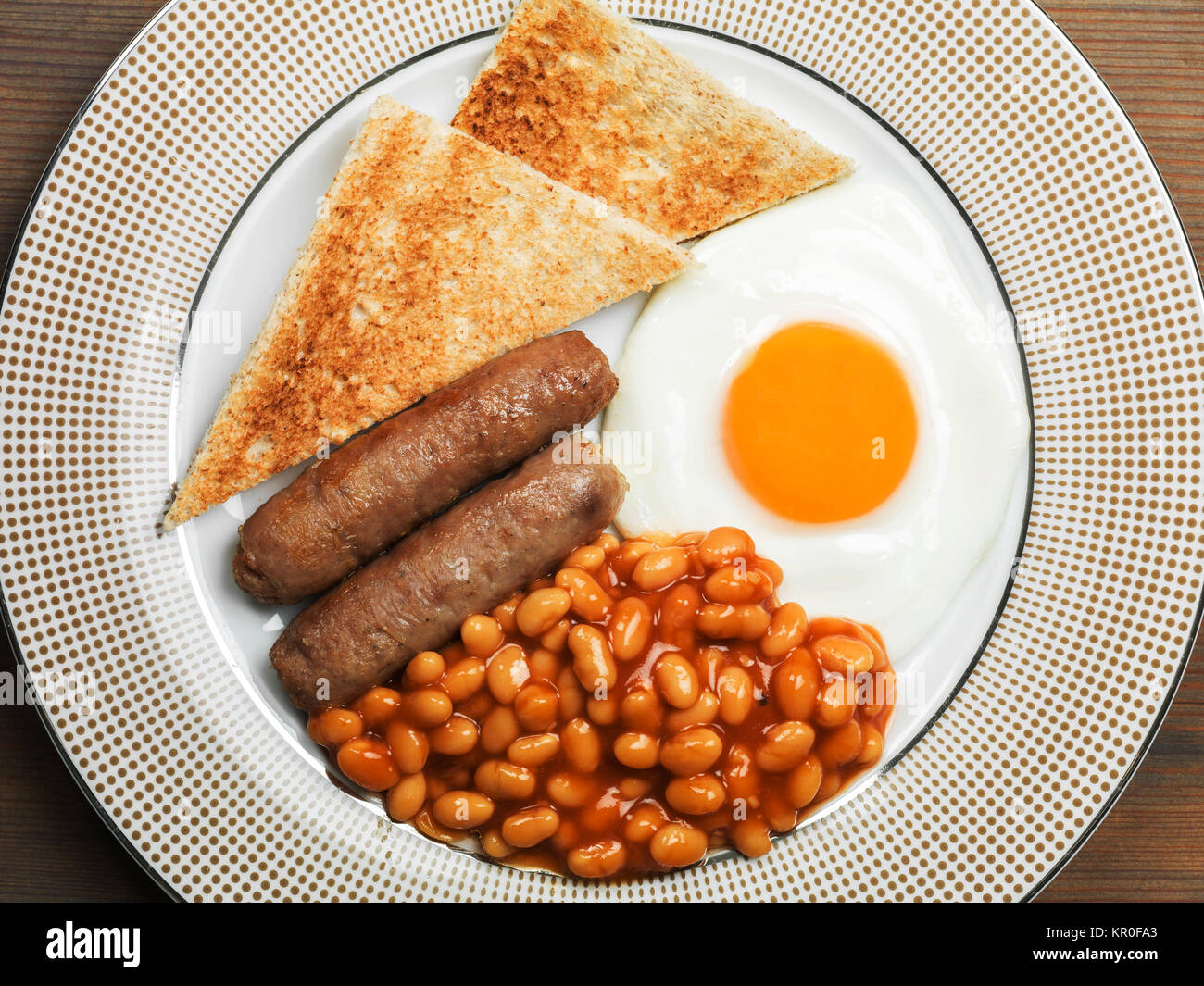 Cooked Fried English Breakfast of Pork Sausages Fried Egg and Baked