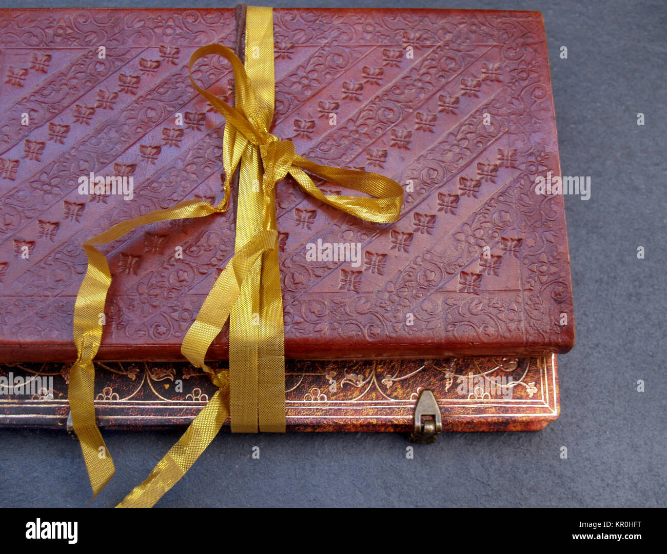Notebook Ribbons Outside Gold bound notebook in leather and tied with a gold ribbon Stock Photo - Alamy