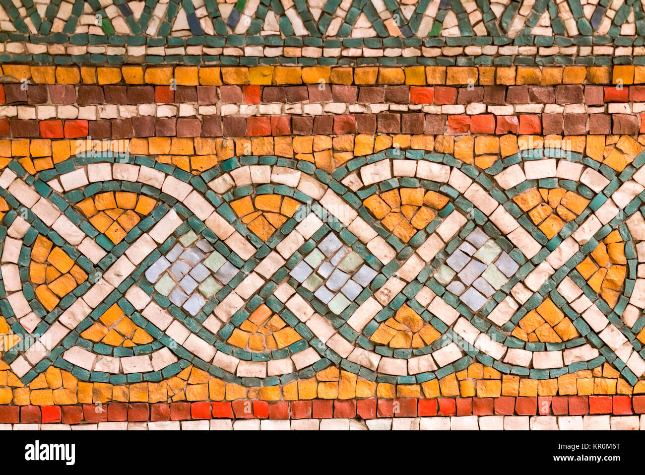 Fragment of ancient mosaic on the wall Stock Photo