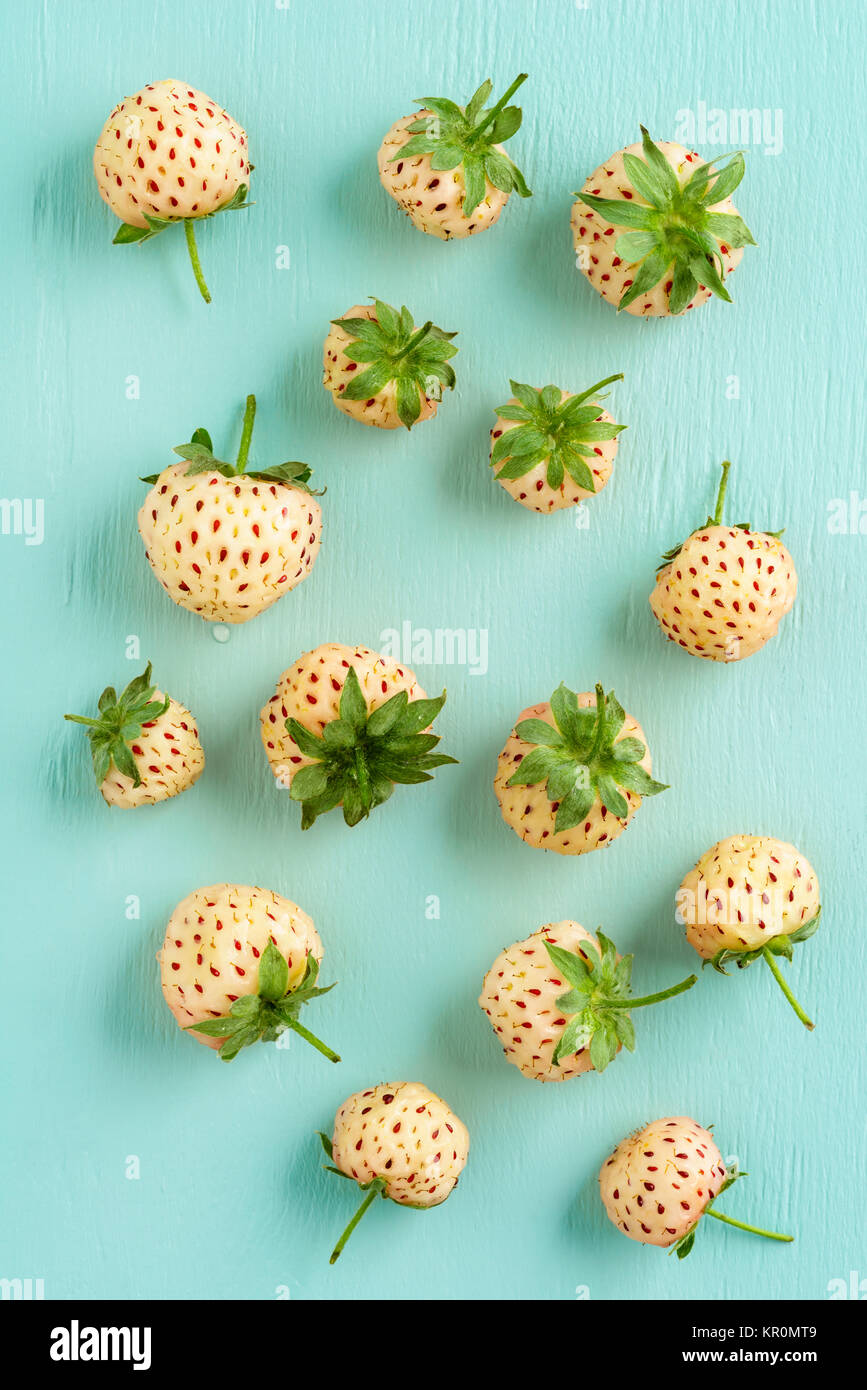 Fresh pineberries on turquoise Stock Photo