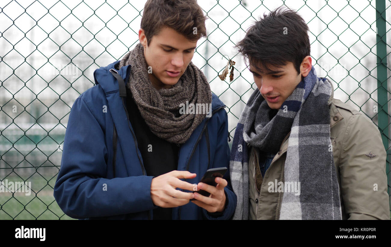 Two young men reading text message or surfing web Stock Photo