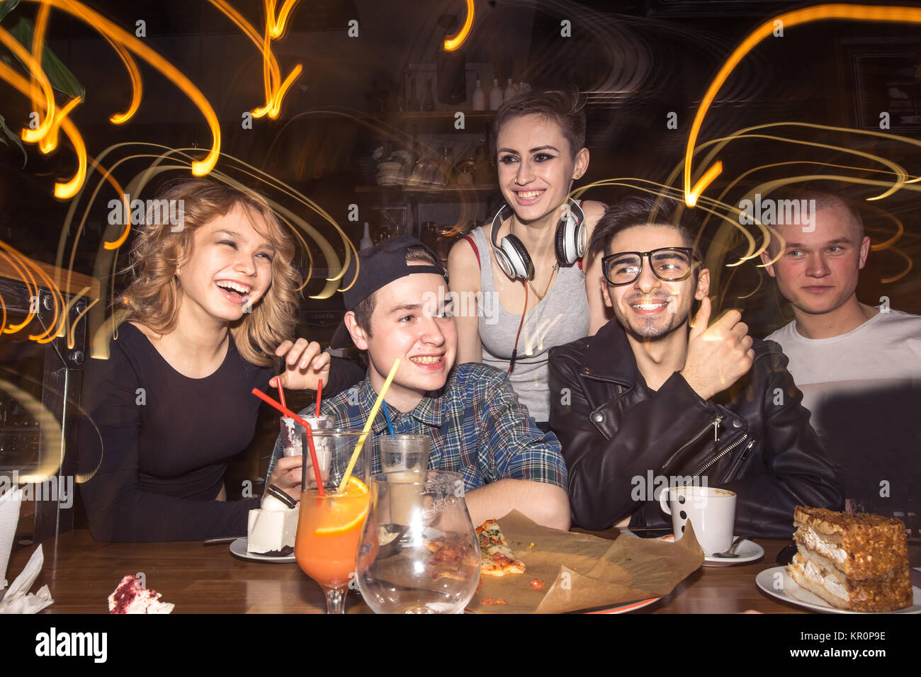 friends having fun and drinking beer in night club. long exposure Stock Photo