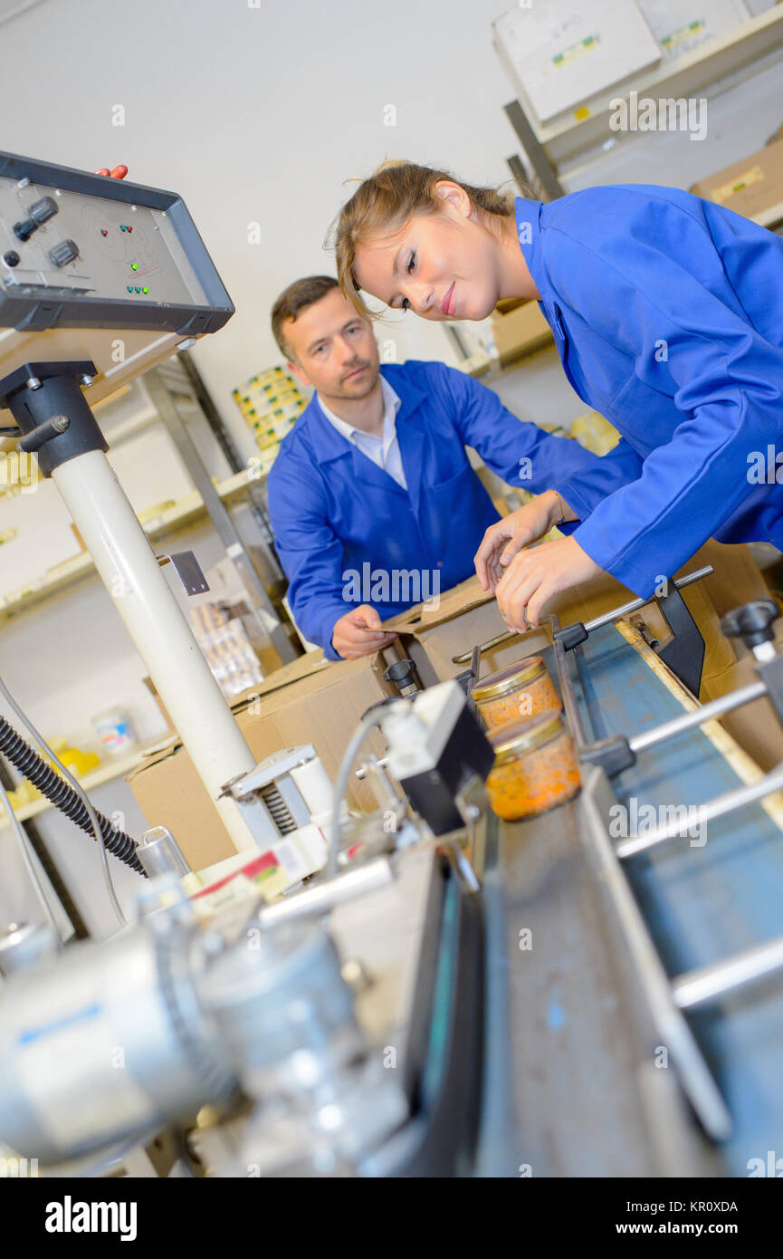 Two workers on production line Stock Photo