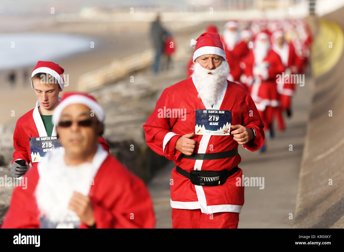 Pictured: Runners in Santa Claus fancy dress take part in this year's run in Aberavon, Wales, UK. Saturday 16 December 2017 Re: 500 people have taken  Stock Photo