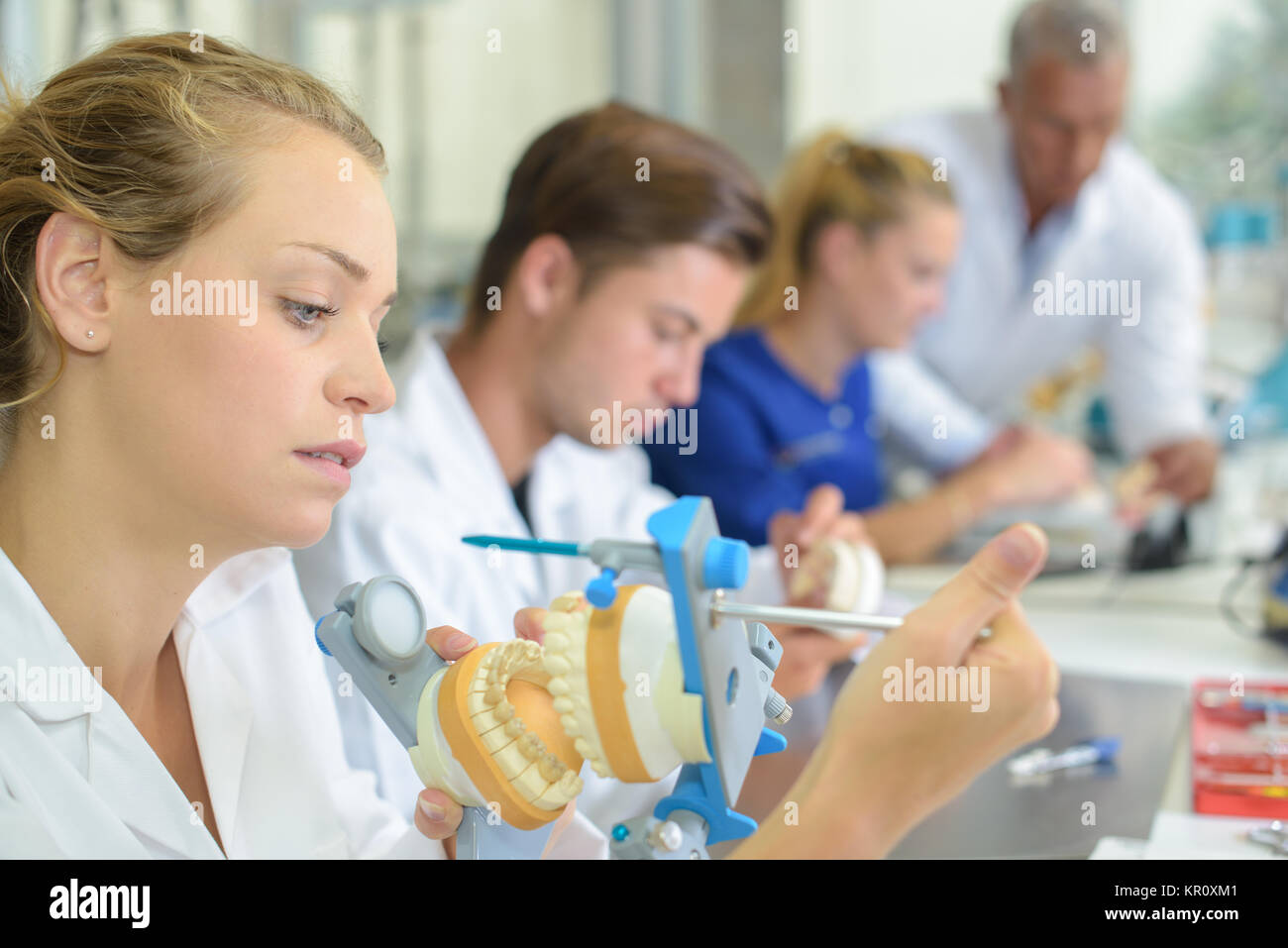 Dental technician clamping impressions together Stock Photo