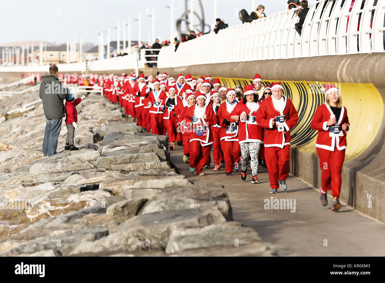 Pictured: Runners in Santa Claus fancy dress take part in this year's run in Aberavon, Wales, UK. Saturday 16 December 2017 Re: 500 people have taken  Stock Photo