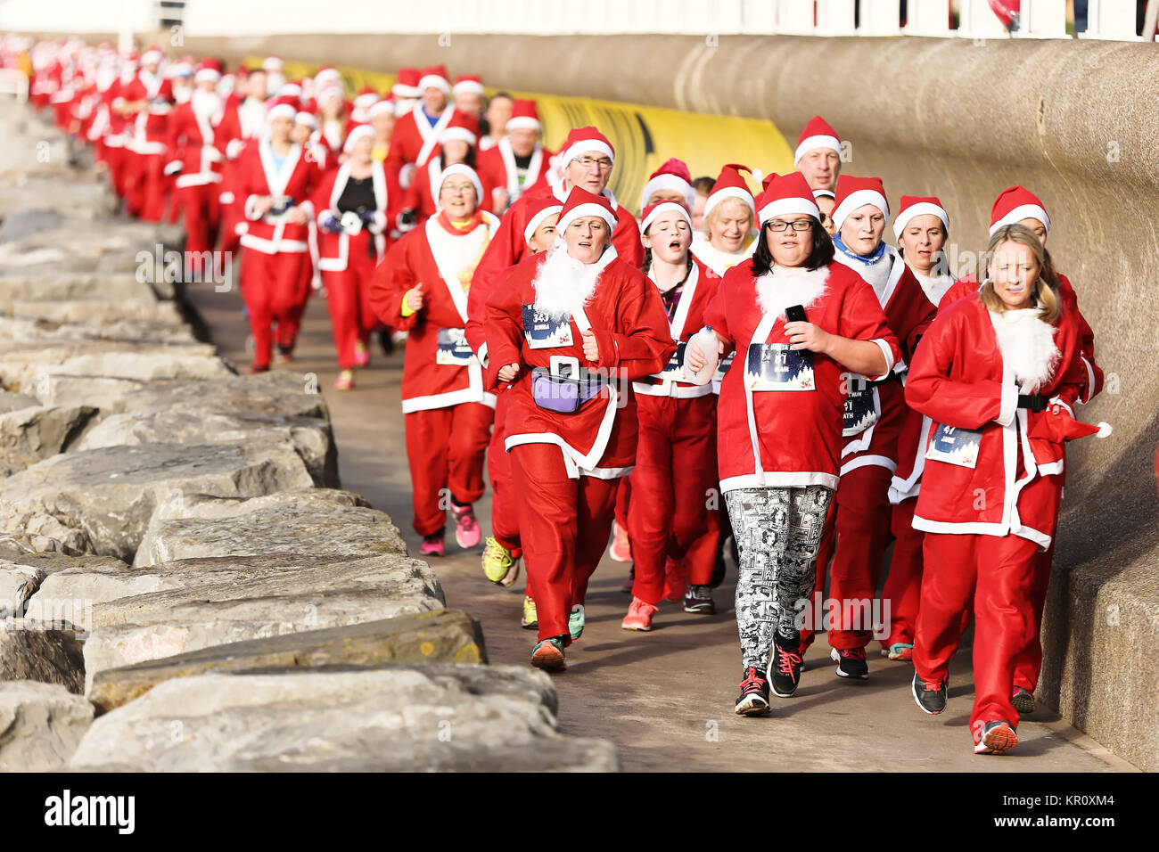 Pictured: Runners in Santa Claus fancy dress take part in this year's run in Aberavon, Wales, UK. Saturday 16 December 2017 Re: 500 people have taken  Stock Photo
