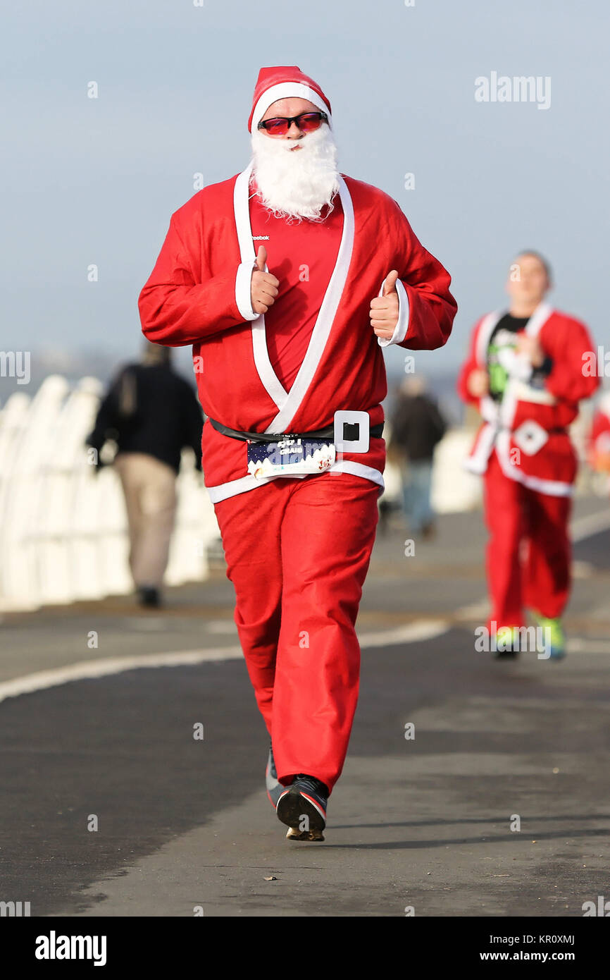 Pictured: Runners in Santa Claus fancy dress take part in this year's run in Aberavon, Wales, UK. Saturday 16 December 2017 Re: 500 people have taken  Stock Photo