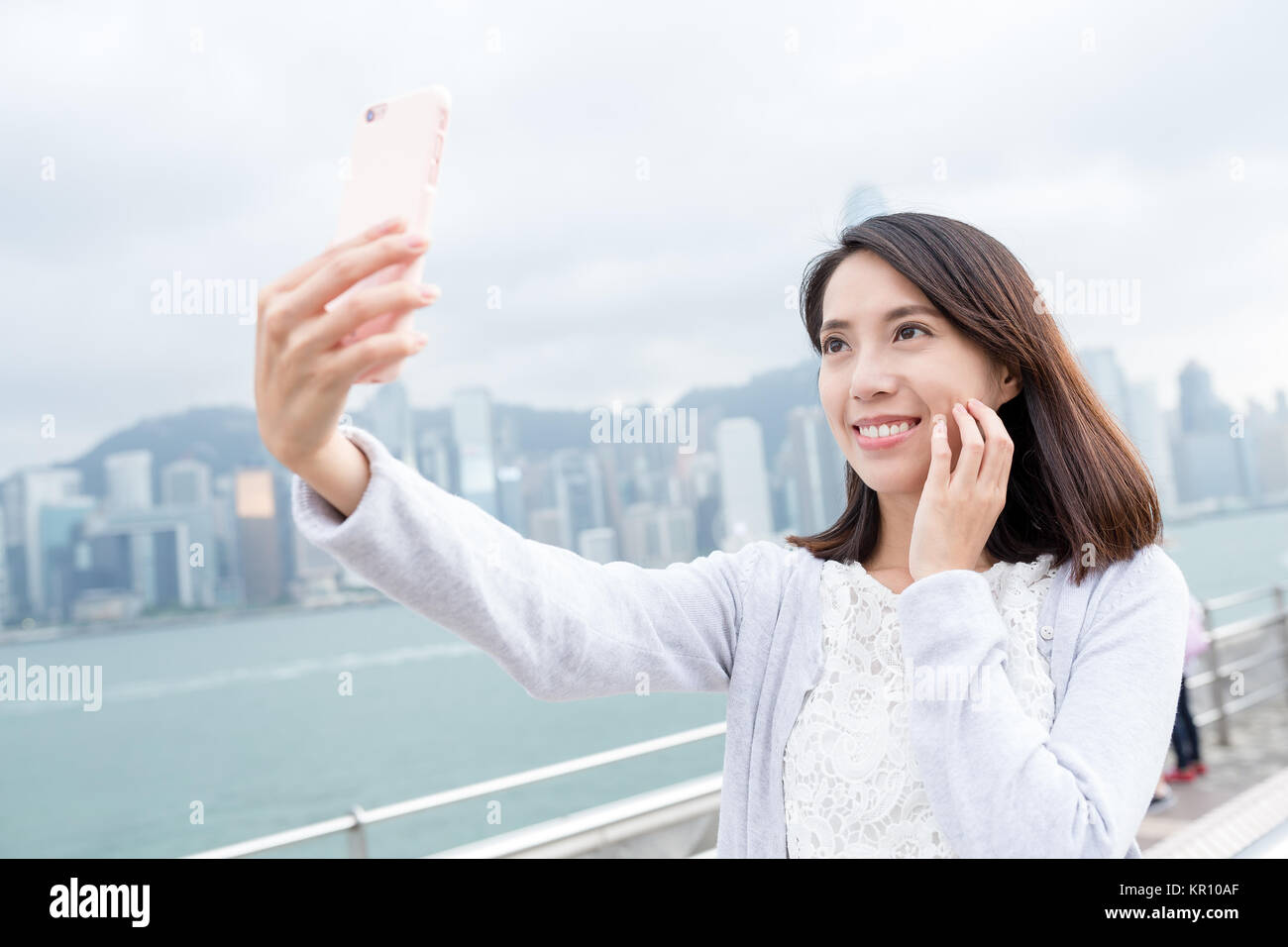 Woman taking selfie in Hong Kong city Stock Photo - Alamy