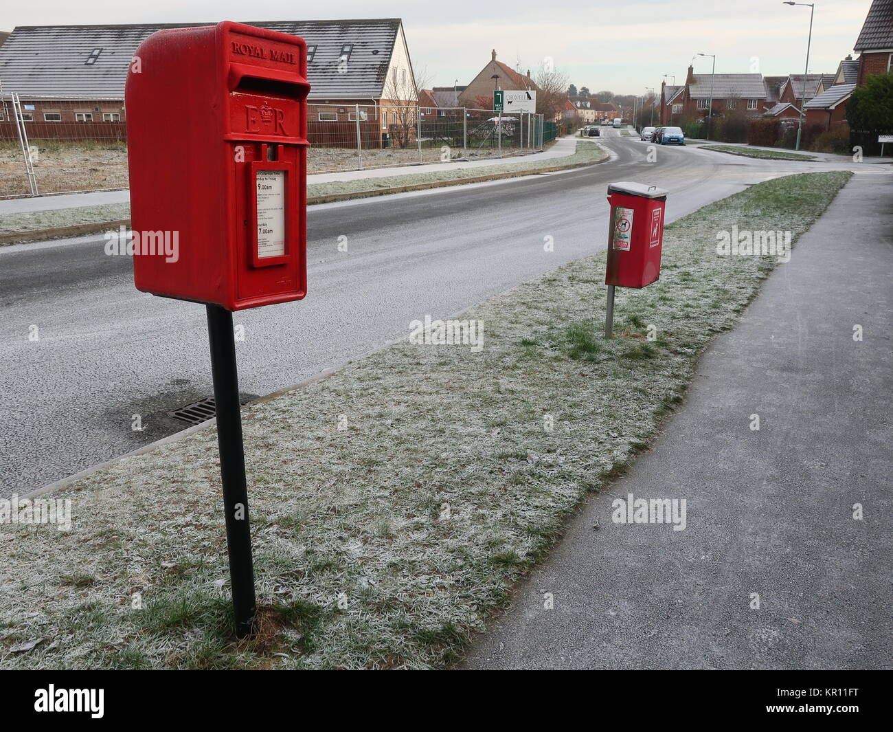 Royal Mail red lamp style letter box / post box and a red fido (dog waste) bin on Hartree Way in Kesgrave, Suffolk. Stock Photo
