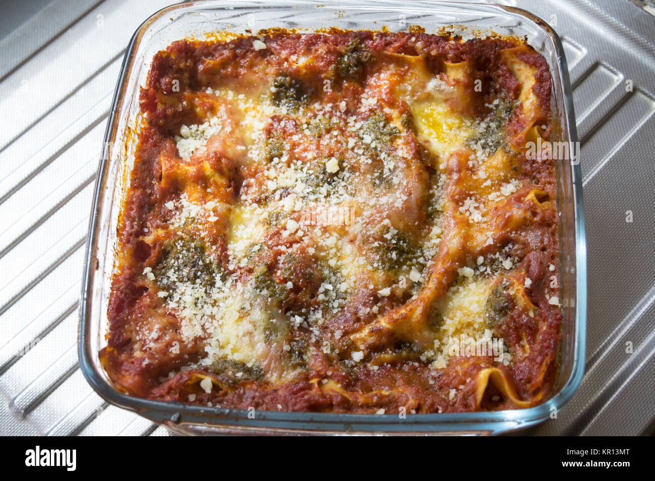 lasagna at basil pesto sauce baked in glass pyrex dish Stock Photo - Alamy
