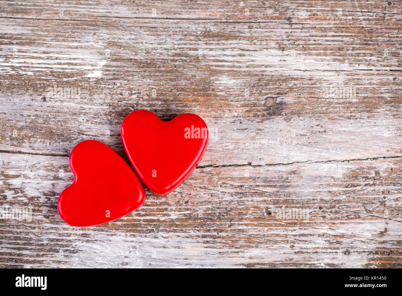 Two red hearts on wood background Stock Photo - Alamy
