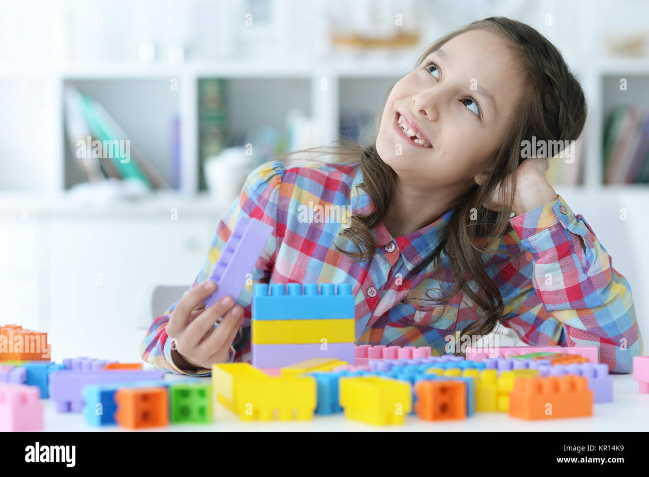 girl playing with plastic blocks Stock Photo - Alamy