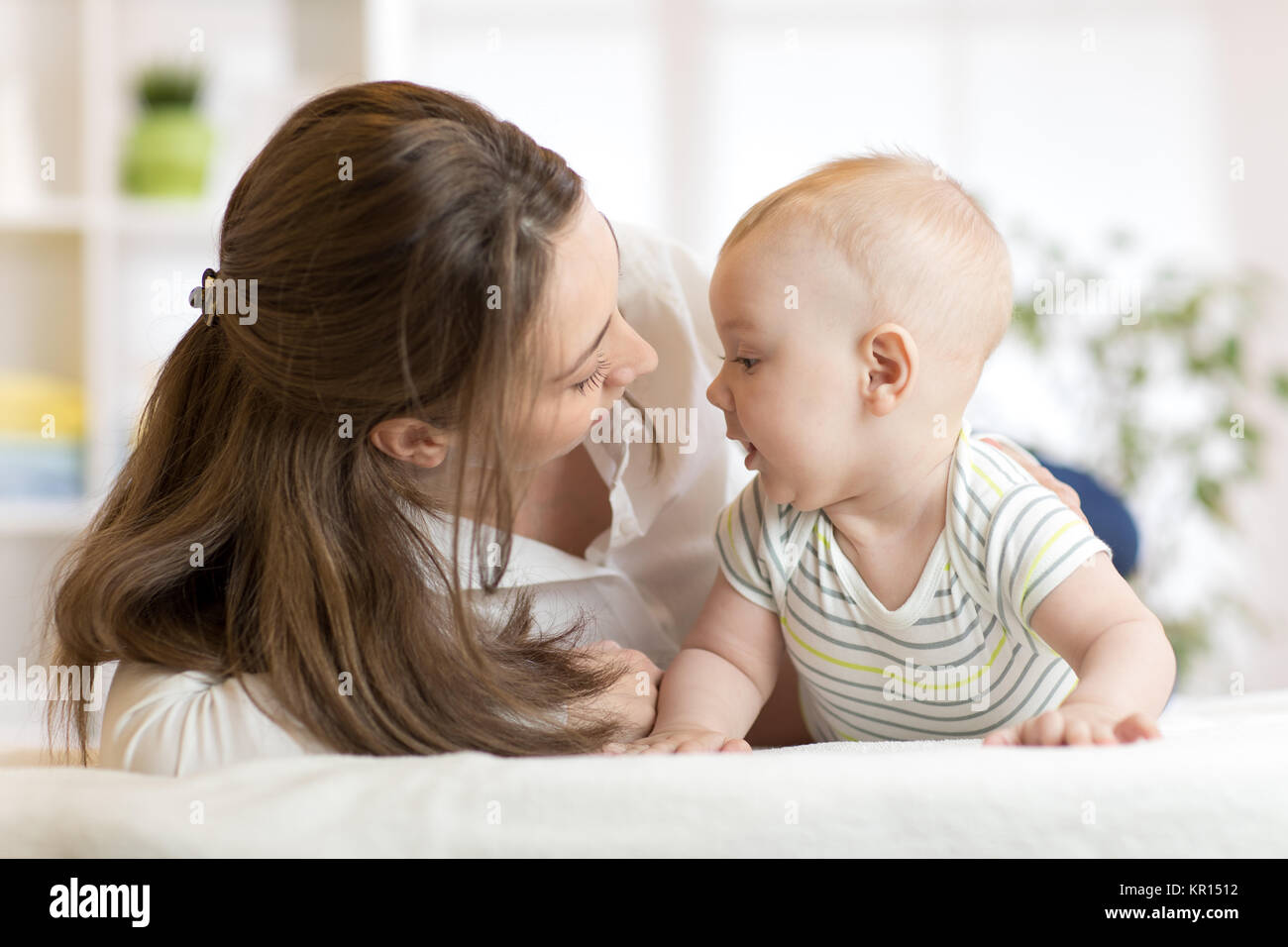 Mommy loving newborn child. Mother communicates with her baby. Stock Photo