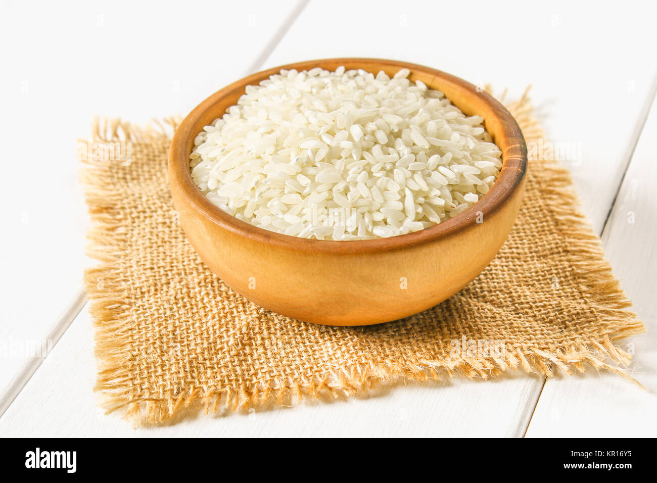 White Items Rice Grains of raw white rice on a white wooden table of boards. Ingredients ...