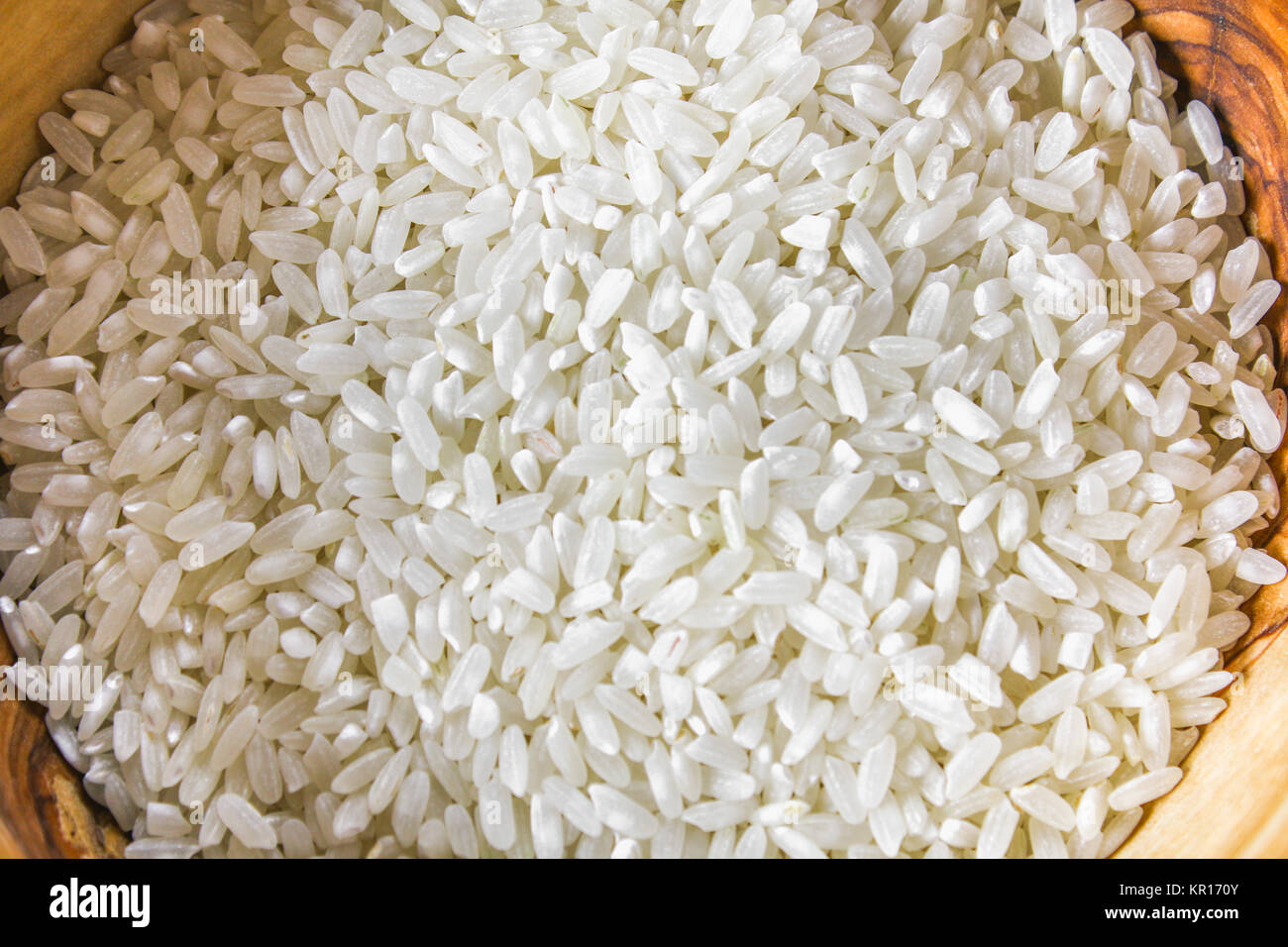 White Items Rice Grains of raw white rice on a white wooden table of boards. Ingredients ...