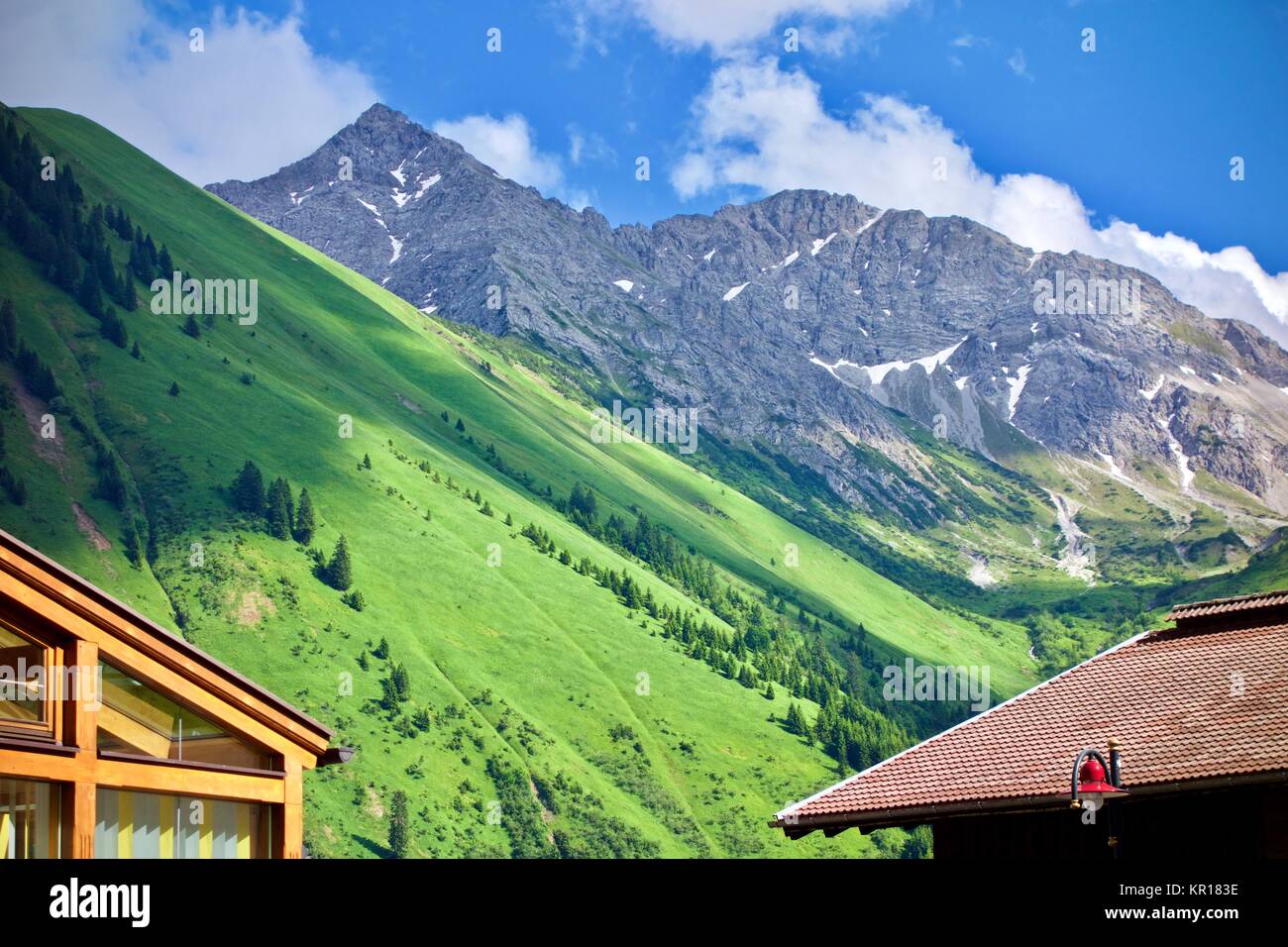Peaceful scenic landscape of lush green alpine peaks and valley under a ...