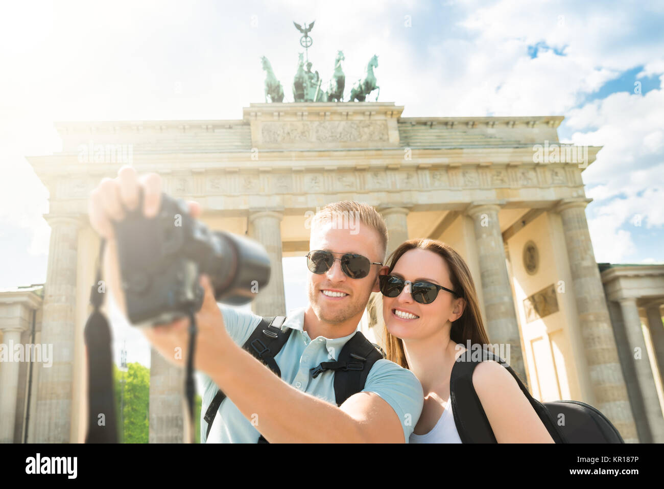 Young Couple Taking Selfie In Front Of Brandenburg Gate Stock Photo