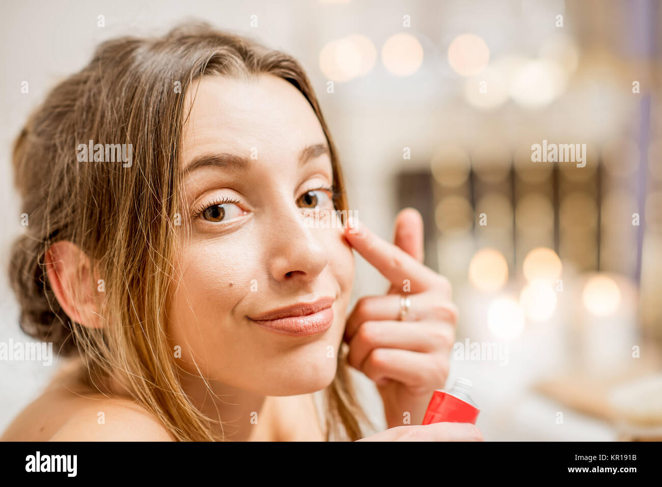 Woman with facial cream in the bathroom Stock Photo Alamy