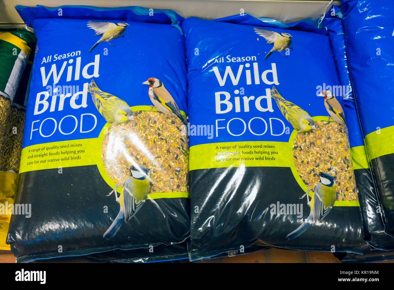 Large bags of All-Season wild bird food for sale in a garden centre Stock Photo