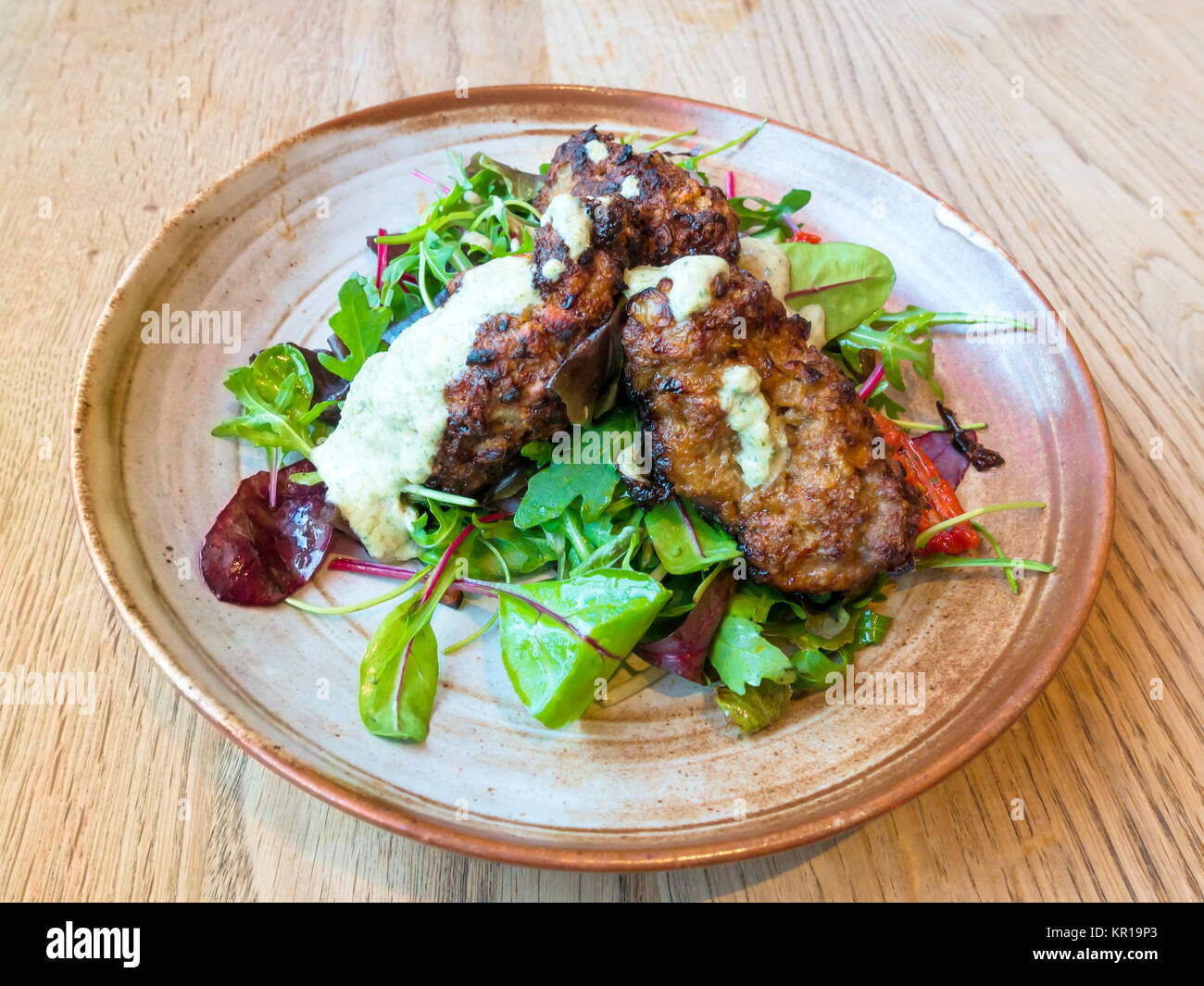 Café lunch Lamb Kofte a Greek dish of lamb and mint meat balls served with a salad Stock Photo