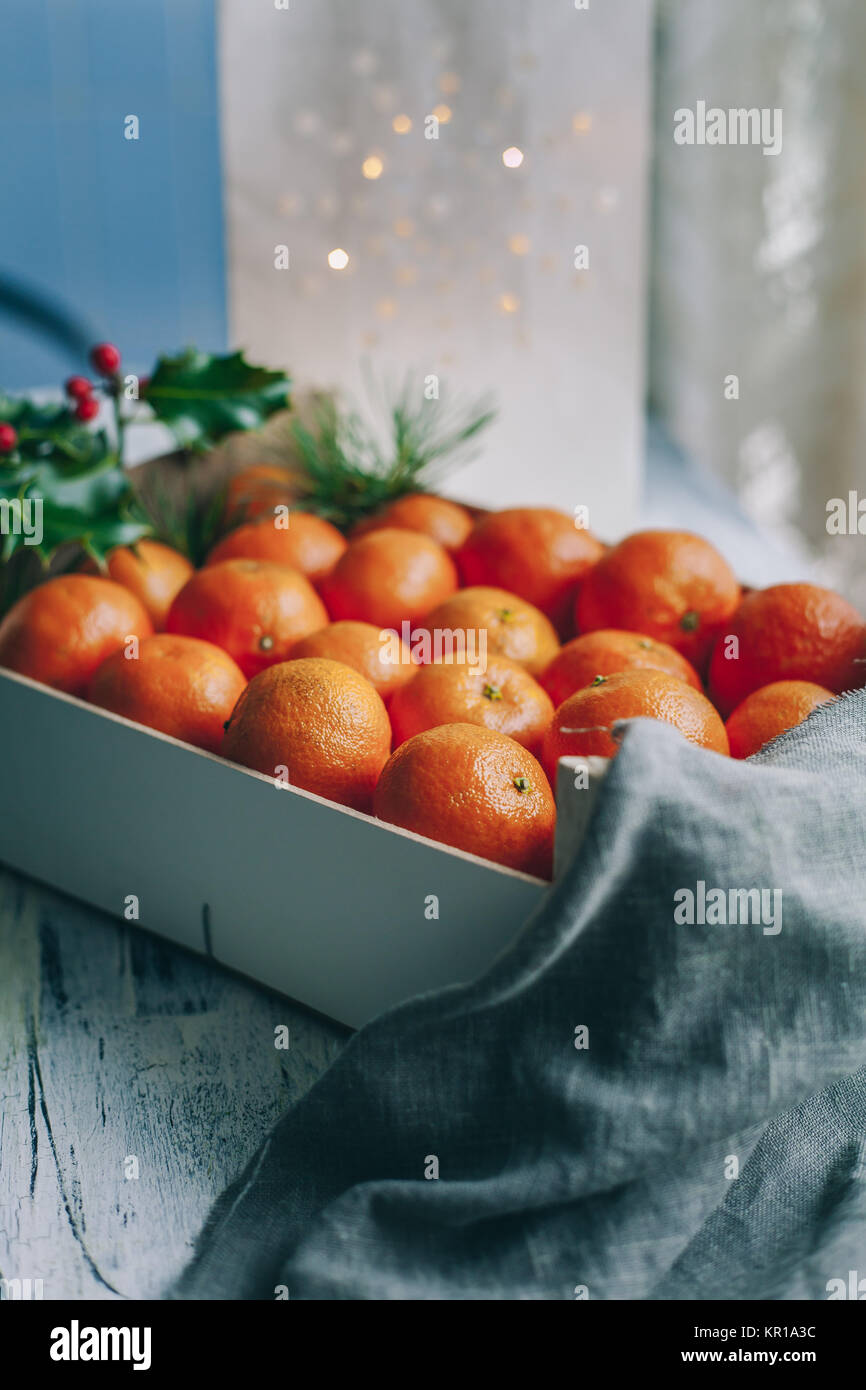Crate of satsumas with Christmas decorations Stock Photo Alamy