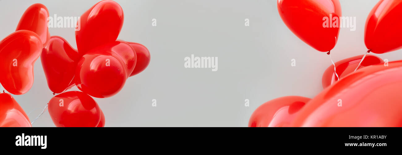 Balloons red heart on a white wall background Stock Photo - Alamy