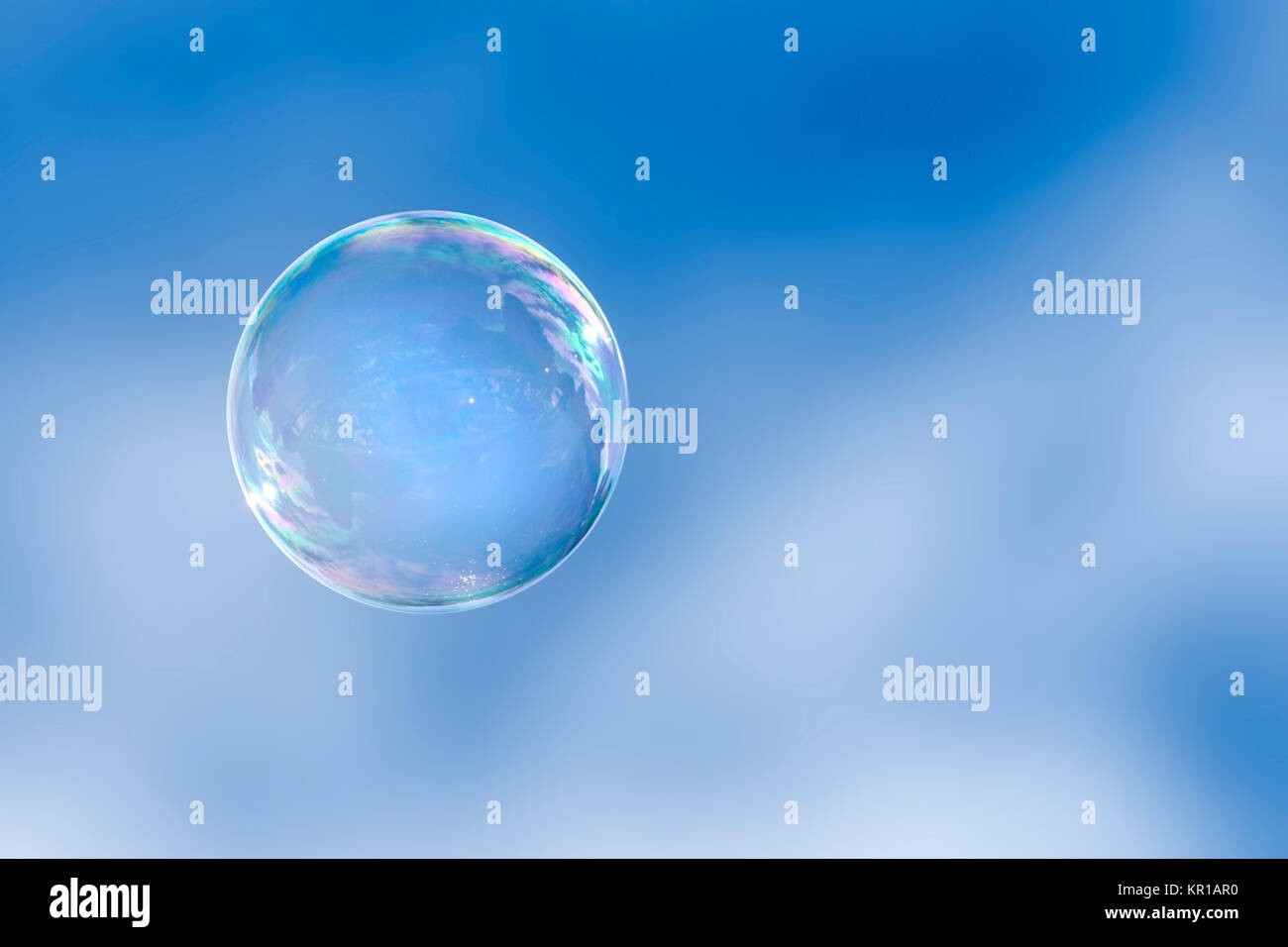 Soap bubble floating in a blue sky Stock Photo