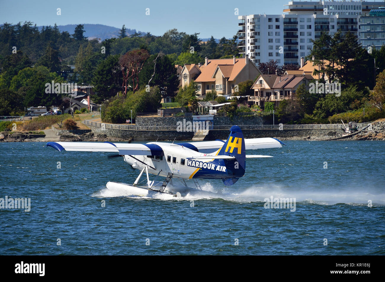 A commuter aircraft speeding up for take off in the harbour at Victoria on Vancouver Island British Columbia Canada. Stock Photo
